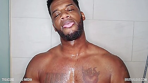 Slender man strokes his big black cock in the shower