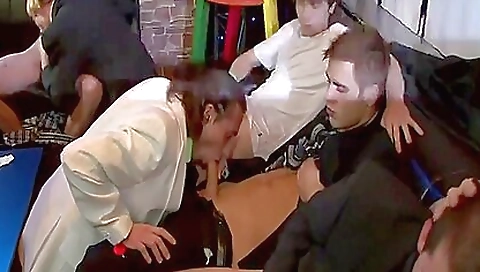 Redhead and brunette sucking each other in a group sex