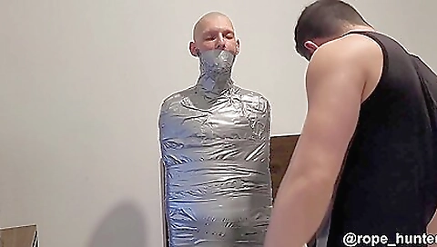 Brunette with a tattooed pussy is going to be turned into a mummy